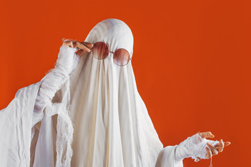 Happy Halloween. Cute funny Ghost on a bright orange background