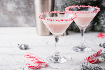 Pink peppermint martini with candy cane rim