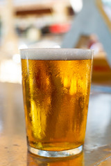 Cold amber color light spanish beer served in glass in outdoor cafe in sunny Andalusia, Spain