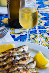 Espeto, Malaga style fish on stick barbecue prepared on olive tree firewoods served with dry fino sherry wine