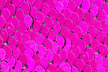 Vibrant pink glitter sequins fabric closeup photo. Feminine party style fabric. Pink glitter texture. Metallic scale background.