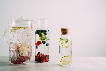 Variety of infused detox water isolated on white, health concept