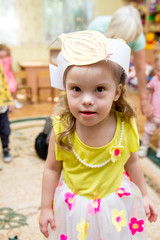 Positive girl with down syndrom looking at camera, party in rehabilitation center