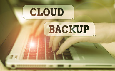 Writing note showing Cloud Backup. Business concept for enable customers to remotely access the provider s is services woman with laptop smartphone and office supplies technology