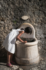 Young girl drinking clean water from the tap
