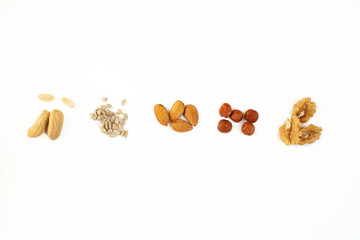 Hazelnuts, walnuts, almonds, cashews and peanuts on white background