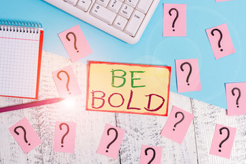 Text sign showing Be Bold. Business photo text Go for it Fix it yourself instead of just talking Tough Hard Writing tools, computer stuff and math book sheet on top of wooden table