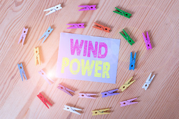 Handwriting text Wind Power. Conceptual photo use of air flowto provide mechanical power to turn generators Colored clothespin papers empty reminder wooden floor background office