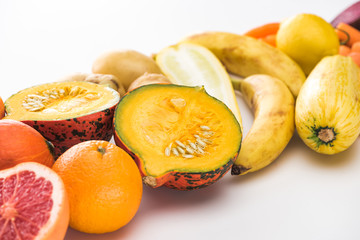 oranges, pumpkin, bananas, zucchini, lemon on white background