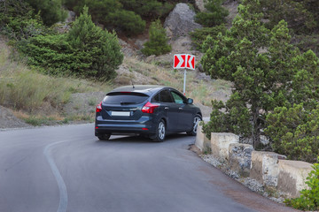 Car move along a winding mountain road