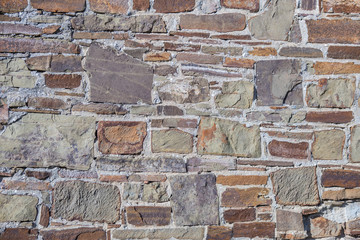 Stone wall of rough unprocessed stones