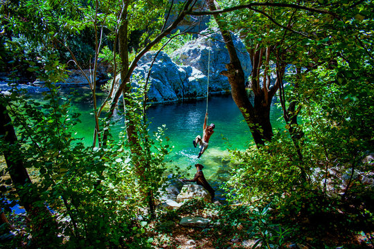 Man jumping to the lake with the rope at the National Park with lake and river in Kaz Mountain, Kaz Daglari, Mount Ida in the district of Edremit in Balikesir, Turkey