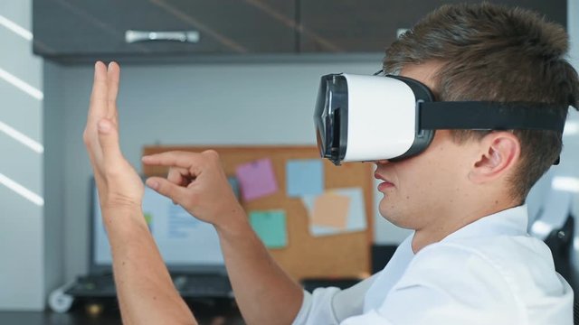 Handsome Businessman With VR Headset Working On a Virtual Business Report. Interactive Business Working Concept