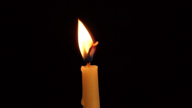 Candle flame fast burning on the wind. Royalty free Full HD stock footage for artistic, holiday, memorial and special event proejects. Cinematic close-up loop. 