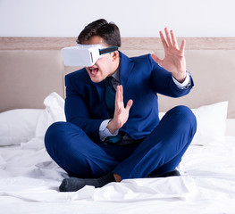 Businessman wearing a virtual reality headset in the bedroom