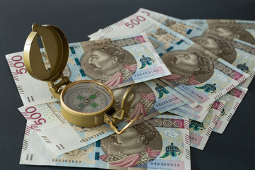 Polish money, 500 zloty Banknotes and compass / business direction concept