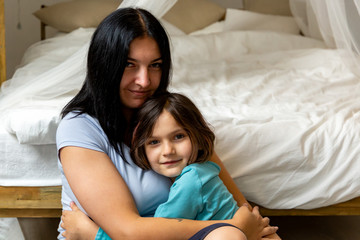 Portrait of mom hugging her daughter