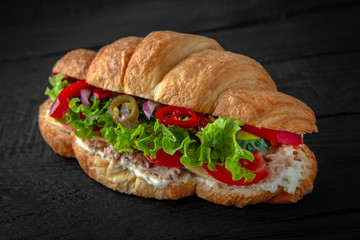 Vegetarian Croissant sandwich with herbs, tuna, hot pepper and sauce. Healthy, tasty, nourishing snack. Take away food