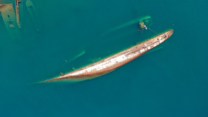 Aerial top down photo of abandoned destroyed industrial ship in Mediterranean destination
