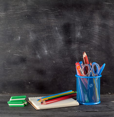 blue stationery glass with multi-colored wooden pencils and pens © nndanko