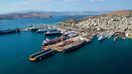 Fototapeta na wymiar Aerial photo of industrial shipyard of Perama repairing small boats near Salamina island, Attica, Greece
