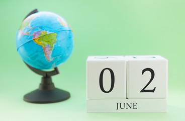 Planner wooden cube with numbers, 2 day of the month of June, summer