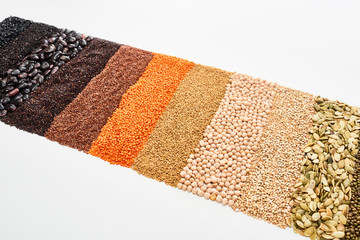 assorted black beans, rice, quinoa, buckwheat, chickpea, pumpkin seeds and red lentil isolated on white