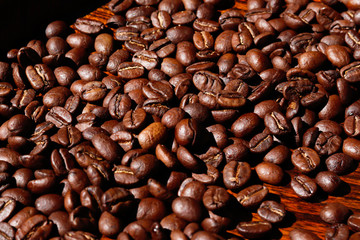 closeup freshness roasted coffee beans full frame spread amount on plank
