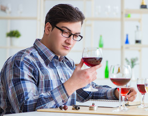 Professional sommelier tasting red wine