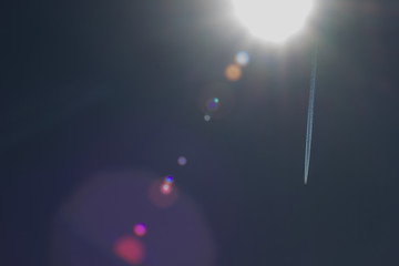 aricraft contrail and  lens flair