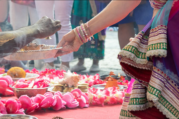 Indian wedding ceremony, decorations for traditional ethnic rituals for marriage, fire burning, flowers and statuettes of the deity on red carpet