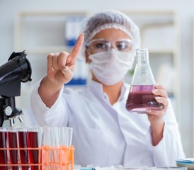 Female scientist researcher conducting an experiment in a labora