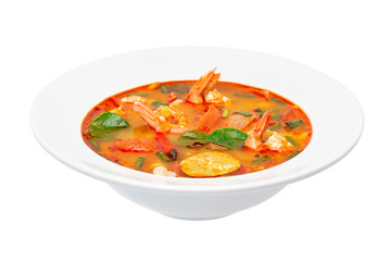 Closeup plate of traditional thai soup - tom yum kung isolated at white background.