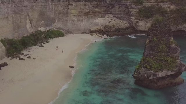 Drone shot flying along the beach at the beautiful Suwehan beach on the island of Nusa Penida, Bali, Indonesia. 