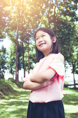 Portrait of a smiling little asian girl in the park.