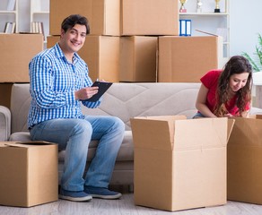 Young pair moving in to new house with boxes