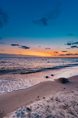 Rocks in the beach during sunest.