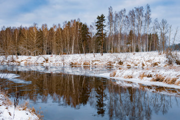 Winter landscape, river and snow covered forest, Latvia.