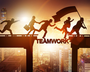 Teamwork concept with business people crossing bridge
