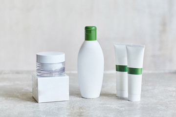 Blank cosmetic tubes on grey background