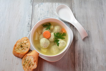 Low fat vegetable soup with chicken meatballs, potato and carrot and fresh herbs in bowl, Healthy food diet