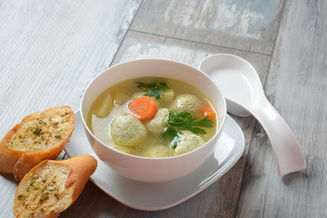 Low fat vegetable soup with chicken meatballs, potato and carrot and fresh herbs in bowl, Healthy food diet
