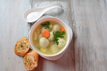 Low fat vegetable soup with chicken meatballs, potato and carrot and fresh herbs in bowl, Healthy food diet