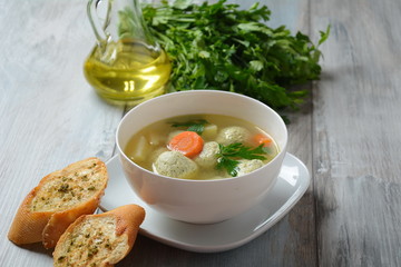 Low fat vegetable soup with chicken meatballs, potato and carrot and fresh herbs in bowl, Healthy food diet