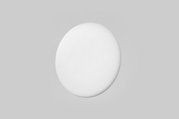 top view of white badge on white background