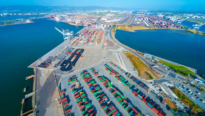 Oakland Harbor port terminal with shipping containers and cranes - obrazy, fototapety, plakaty