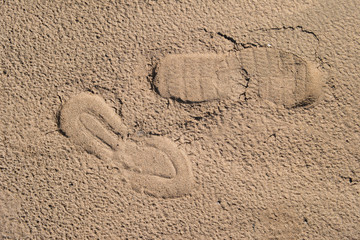 Fototapeta na wymiar Human footprint on the sand. Sand background, texture.