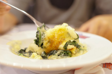 Closed up Baked spinach with cheese - gnocchi casserole