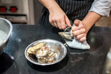 Chef opened fresh oyster in restaurant kitchen