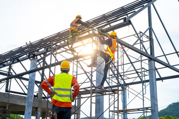 Engineer technician watching team of workers on high steel platform,Engineer technician Looking Up...